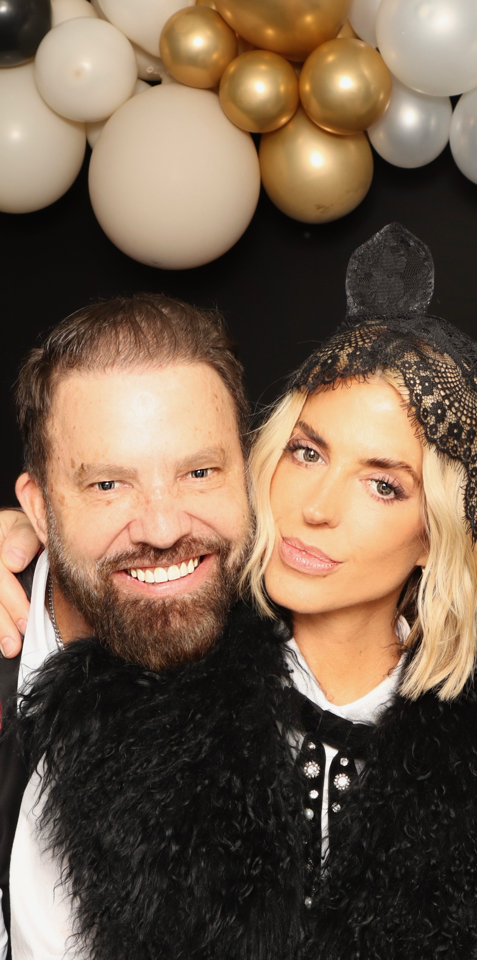 Photo booth portrait beneath the balloons
